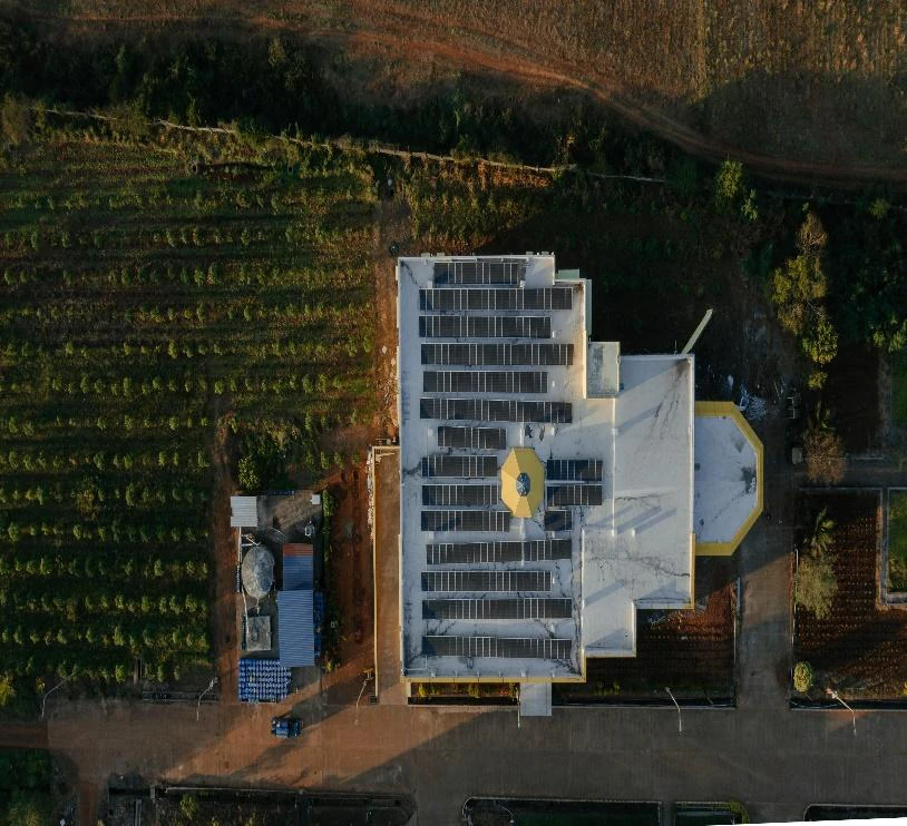 Top-down aerial view of the MM Industries rooftop solar installation